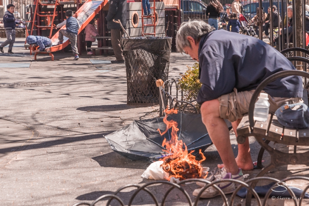 Man heating his feet, Chinatown 4/8/2017